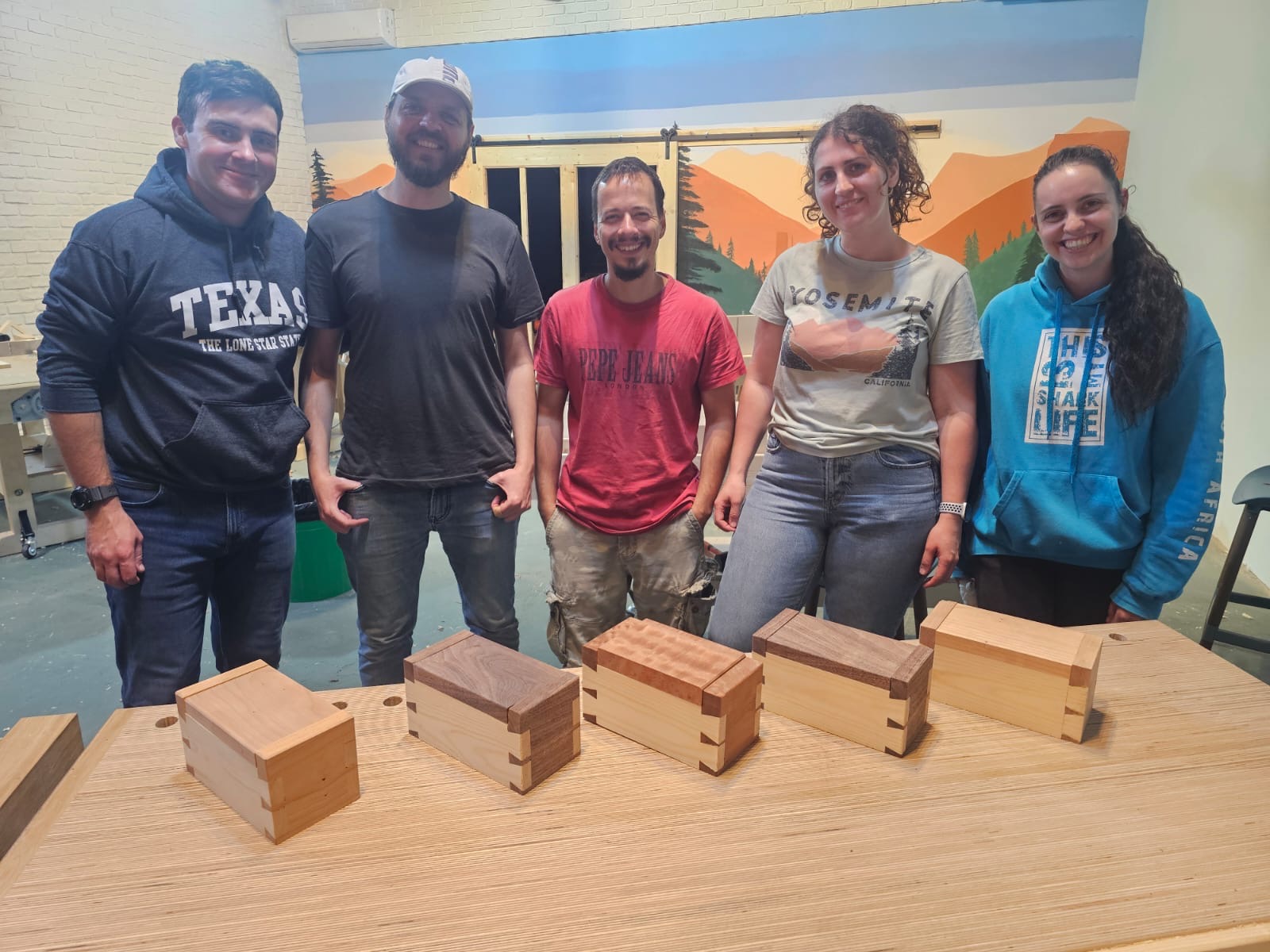 Group proudly displaying their completed wooden boxes